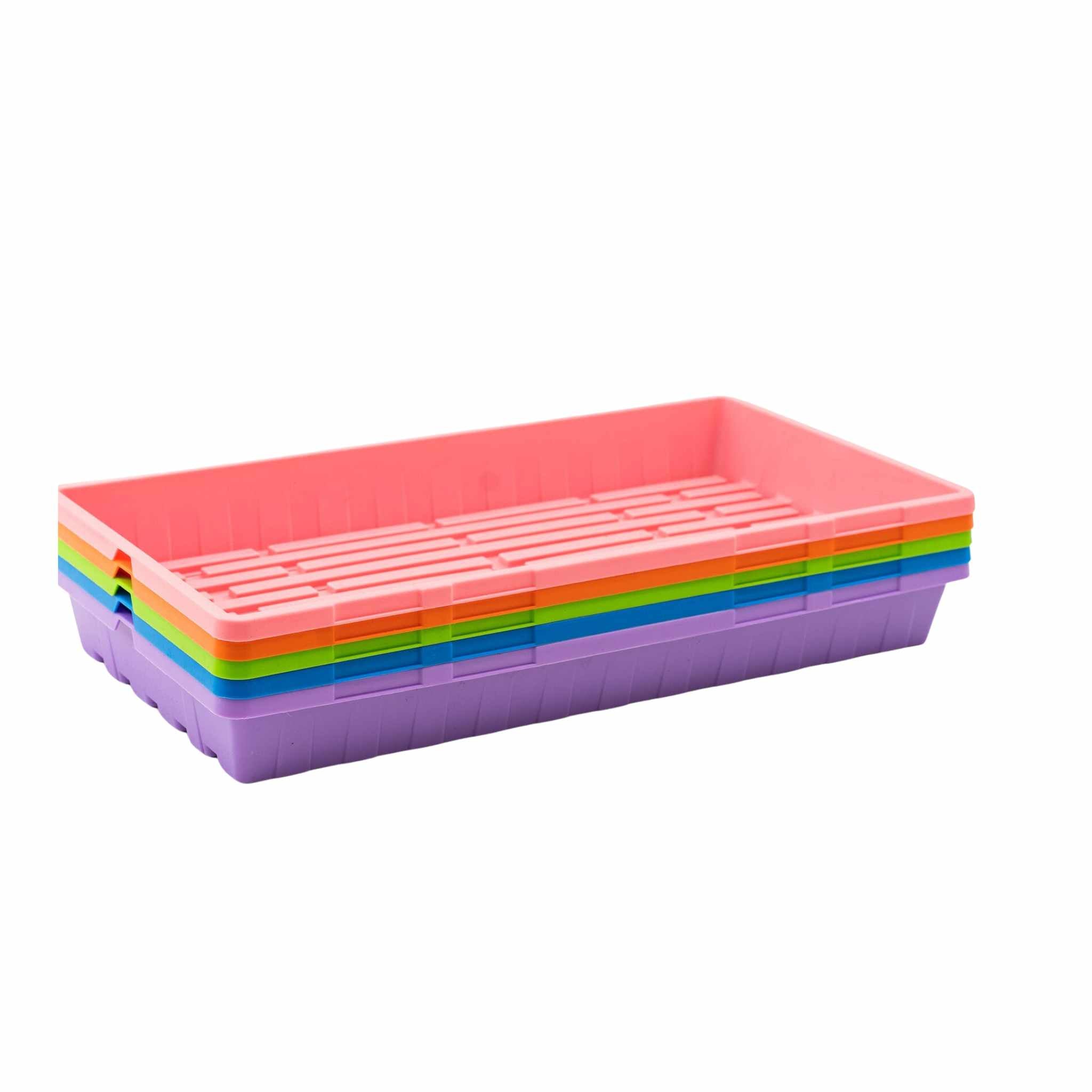 Stack of colorful plastic gardening trays on a white background