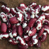 Red and white Anasazi beans on a brown surface