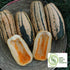 Candystick delicata squash with a halved squash showing orange flesh on a woven surface, with &