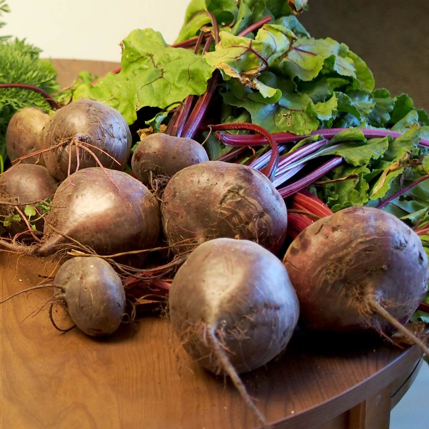 Lutz green leaf beets with green leaves on a wooden surface