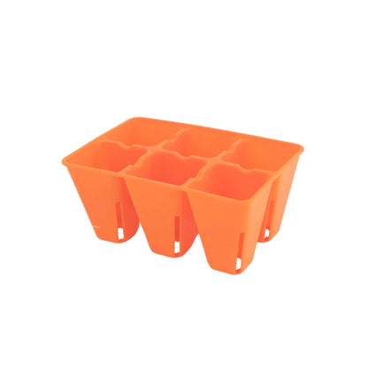 Orange plastic seed tray with multiple compartments on a white background 