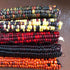 Multicolored painted mountain flour corn cobs stacked on a brown surface