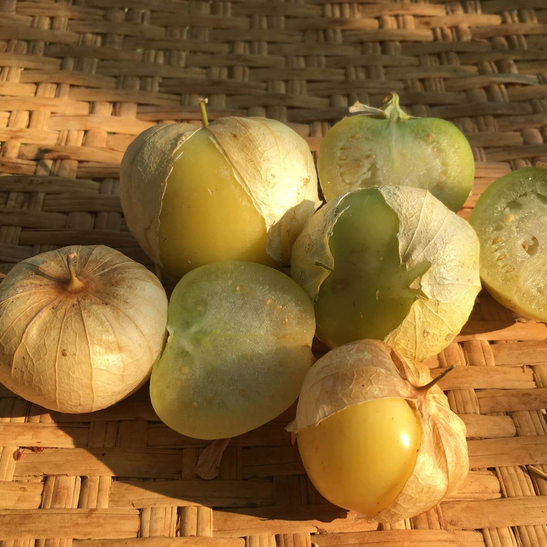 Tomatillo verde on a woven surface