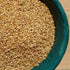 A bowl filled with tan sesame seeds.